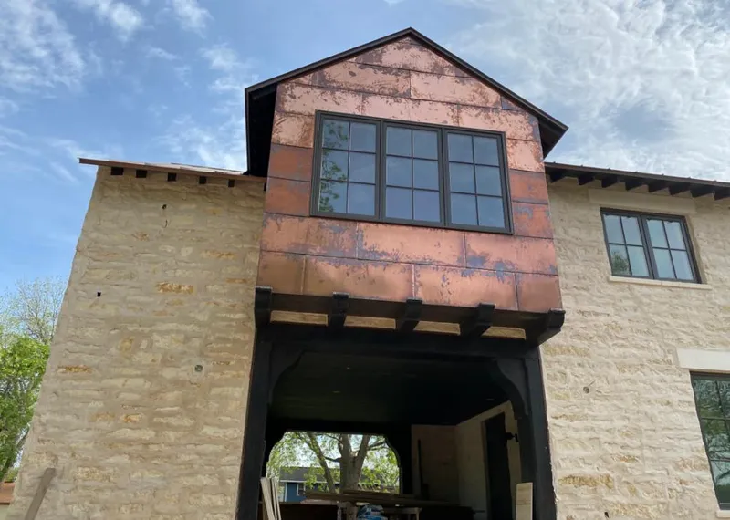 Copper metal panel facade on a stone building for Skylight Installation in Suwanee