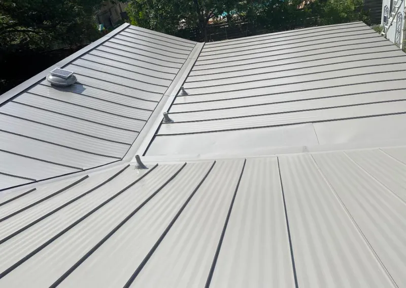 Solar attic fan installed on a metal roof for Roof Ventilation in Suwanee